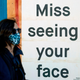A woman in a face mask walks by a sign posted on a boarded up restaurant in San Francisco, California on April, 1, 2020